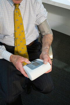 Businessman checking blood pressure in an office