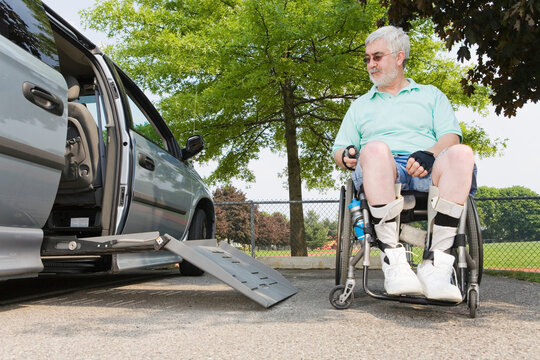 Man with Muscular Dystrophy in a wheelchair exiting an accessible van