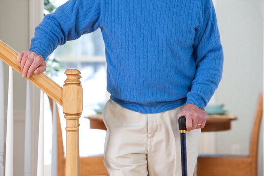 Man with Parkinson's disease and multiple sclerosis standing near steps