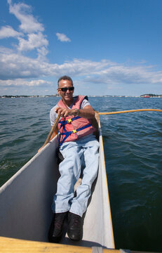 Man with spinal cord injury outrigger canoeing in the sea