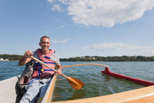 Man with spinal cord injury outrigger canoeing in the sea