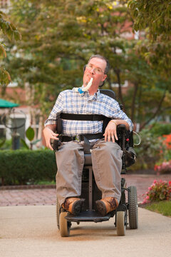 Man with a Duchenne muscular dystrophy sitting in a wheelchair