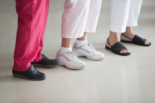Low section view of three women standing in a row