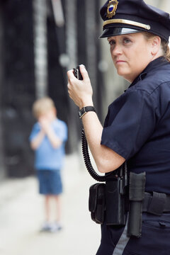 Woman police officer talking on hand mike