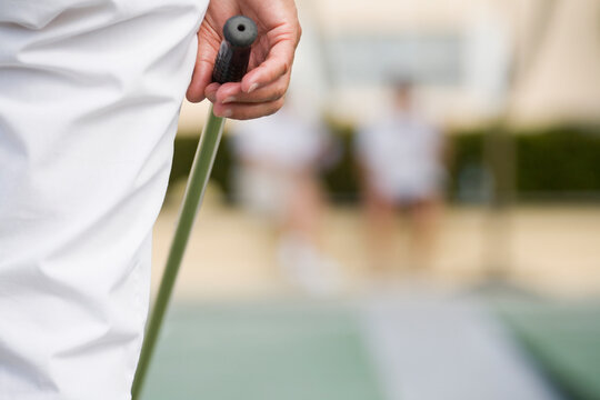Close-up of a senior man playing shuffleboard