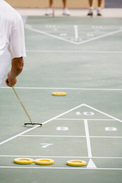 Senior man playing shuffleboard