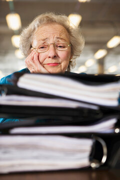 View of a senior woman tensed with workload