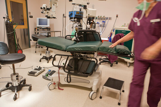 Surgical technologist getting operating room ready for next case