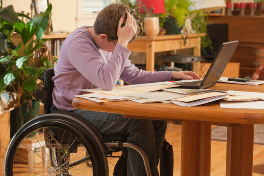 Businesswoman with multiple sclerosis concerned about her paperwork at home
