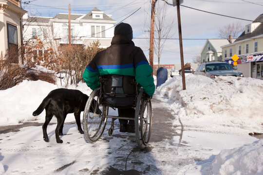 Woman with multiple sclerosis trying to get to the mailbox with a service dog