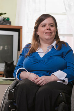 Close-up of a woman with Spina Bifida in a wheelchair smiling