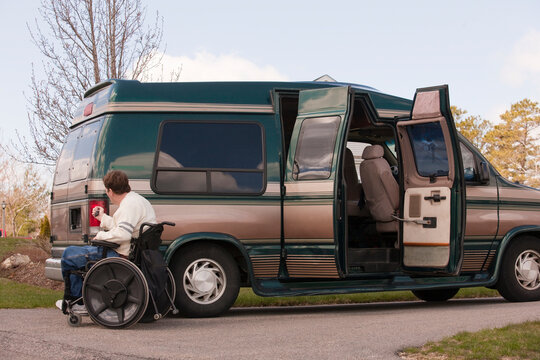 Man with spinal cord injury using magnetized remote to close his accessible vehicle