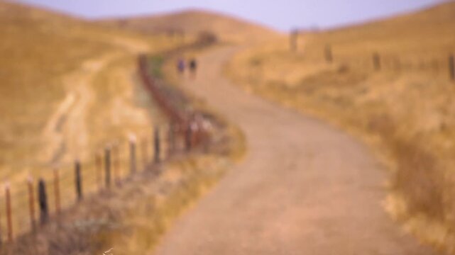 soft focus runners training for a marathon on a dirt road