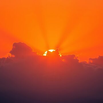 Orange sunrise with rays shining through clouds, dawn, orange