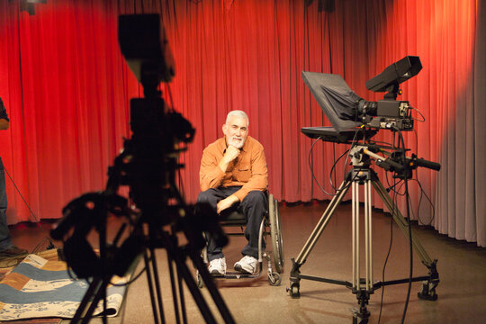 Announcer with muscular dystrophy relaxing in TV studio