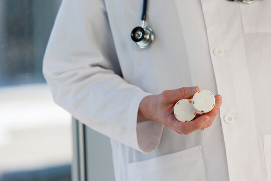 Doctor holding bottles of medicines