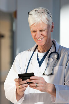 Doctor text messaging on his smartphone