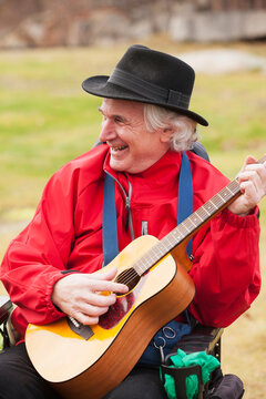 Musician with Multiple Sclerosis in a motorized wheelchair playing his guitar