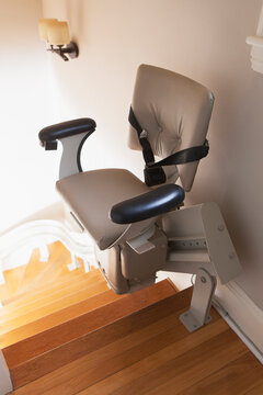 Motorized stair lift chair at top of stairs