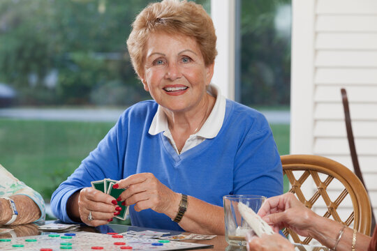 Senior women playing cards
