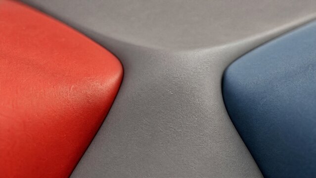 Smooth gray material filling junction between two colored surfaces.