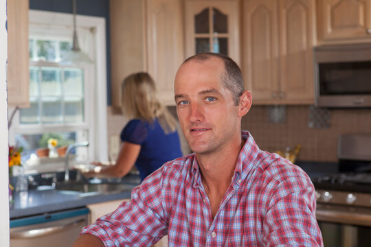 Husband and wife with hearing impairments in their kitchen