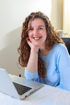 Woman with Muscular Dystrophy working at her laptop in her office