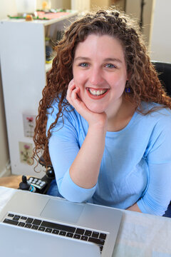 Woman with Muscular Dystrophy working at her laptop in her office