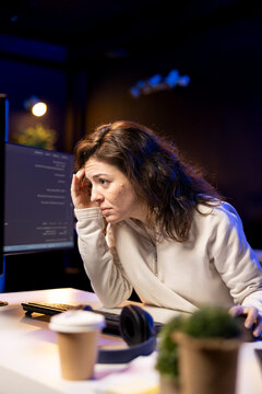 Tired software developer hurting from too much stress accumulated while doing quality assurance, computer scientist suffers from headache after inspecting coding on PC for too long.