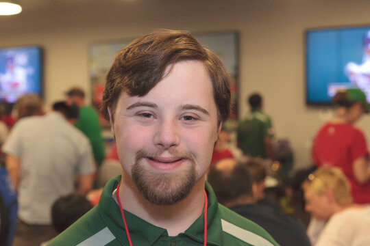Young man with Down Syndrome working at a ball park