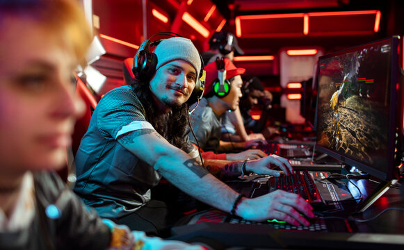 Esports team playing pc game in neon gaming arena