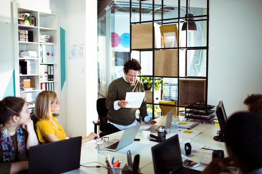 Team collaborating during casual meeting in modern office