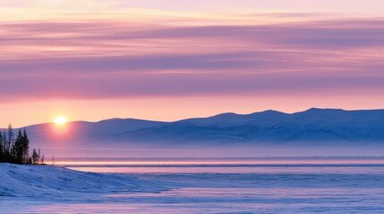 Obraz premium Sunrise over a frozen lake with mountains in the background during early morning hours