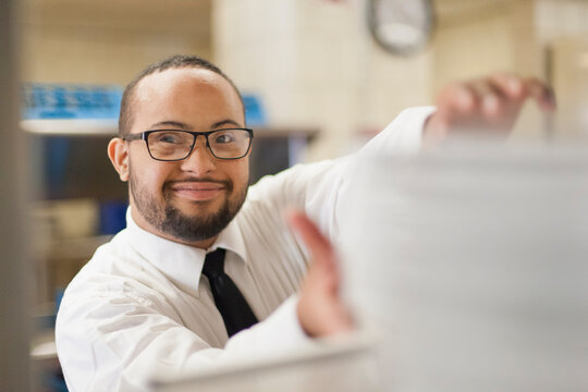 African American man with Down Syndrome as a waiter working in restaurant