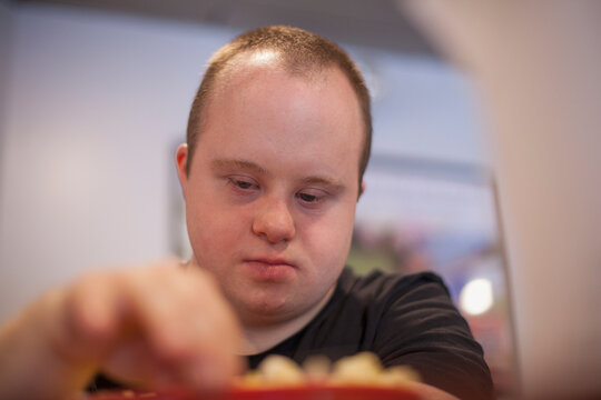 Waiter with Down Syndrome working in a restaurant