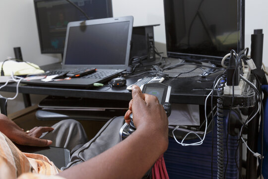 Man with Guillain-Barre Syndrome using his technical equipment at home office