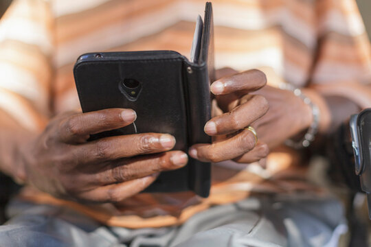Man with Guillain-Barre Syndrome text messaging on his phone