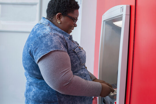 Happy woman with bipolar disorder doing a bank withdrawal