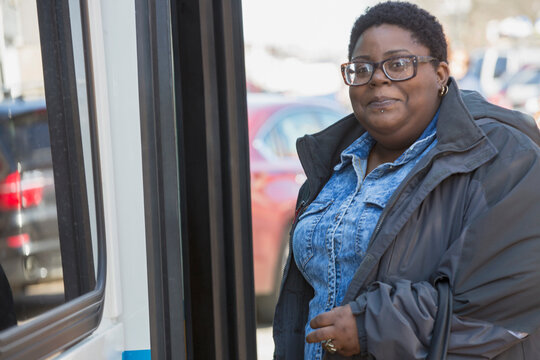 Portrait of a woman with bipolar disorder standing near a bus