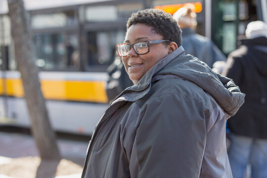 Portrait of a happy woman with bipolar disorder about to take a bus