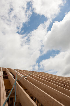 Safety ropes hanging from roof trusses at a house under construction