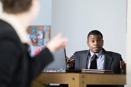 Business colleagues conversing in an office