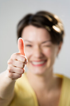 A mid adult woman gesturing