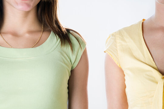 Left shoulder of one woman and right shoulder of another woman