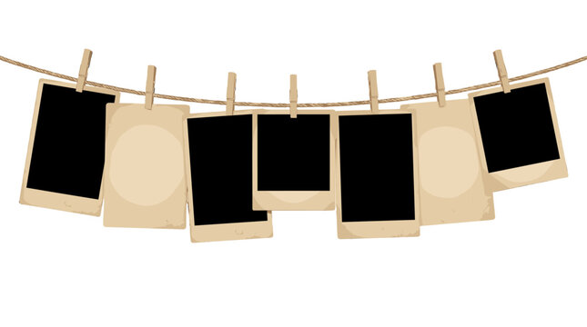 Vintage photo frames and blank cards hanging on a rope