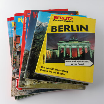 Perth, Western Australia, Australia - May 2 2026: Stack of vintage pocket travel books featuring 1995 Berlin visitor tourist guide of Berlin. Iconic Brandenburg Gate on front page. Vacation planning