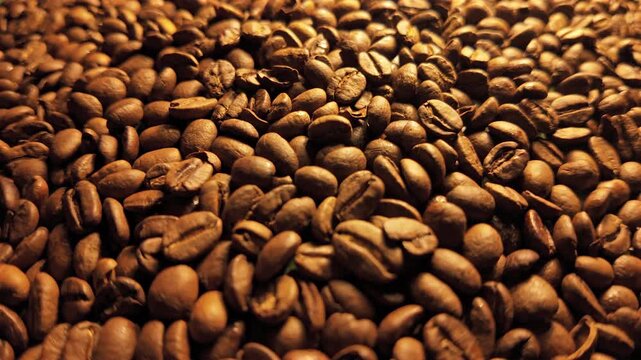 50p POV slider shot moving across roasted coffee beans background
