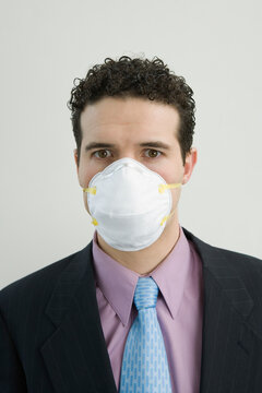 Portrait of a businessman wearing a pollution mask