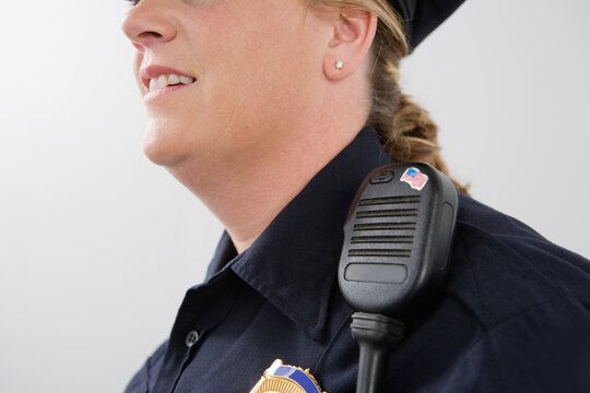 Close up of hand mike on a police woman's shoulder