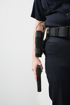 Police woman holding a loaded pistol ready to fire